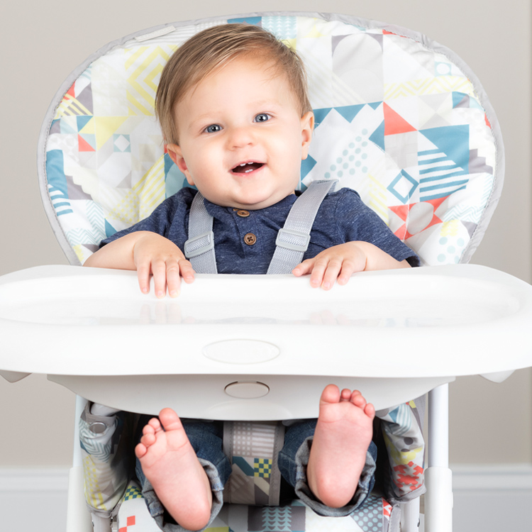 Baby sitting in the Graco Snack N' Stow highchair